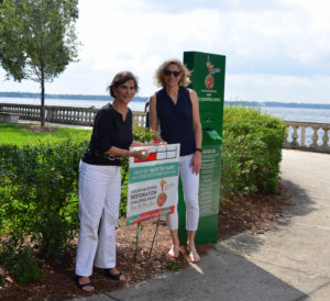 Agnes Danciger, board president and Paula Skitsko, board member, updating the   Restoration Challenge Grant signs in the park.